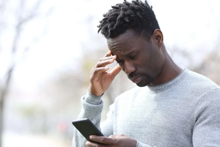 man looks stressed at phone scaled
