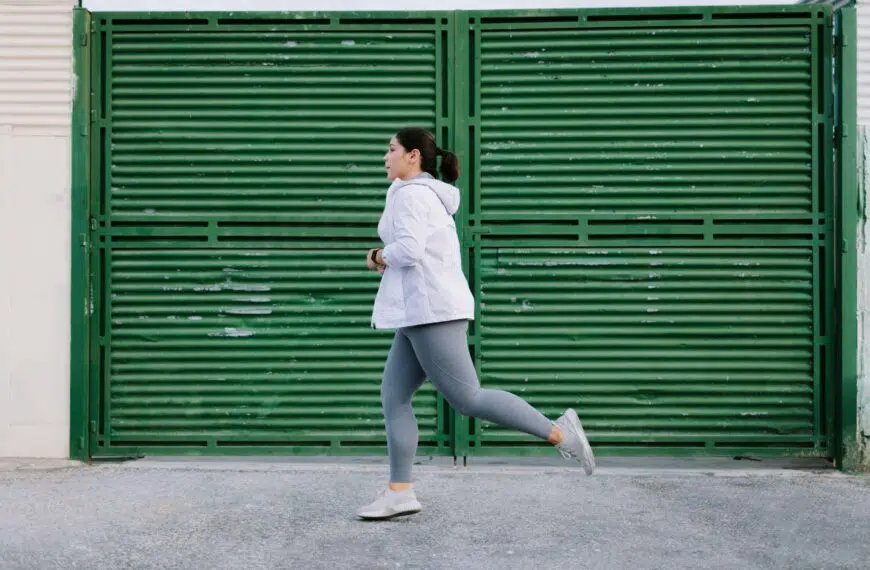 person running against green shutter scaled
