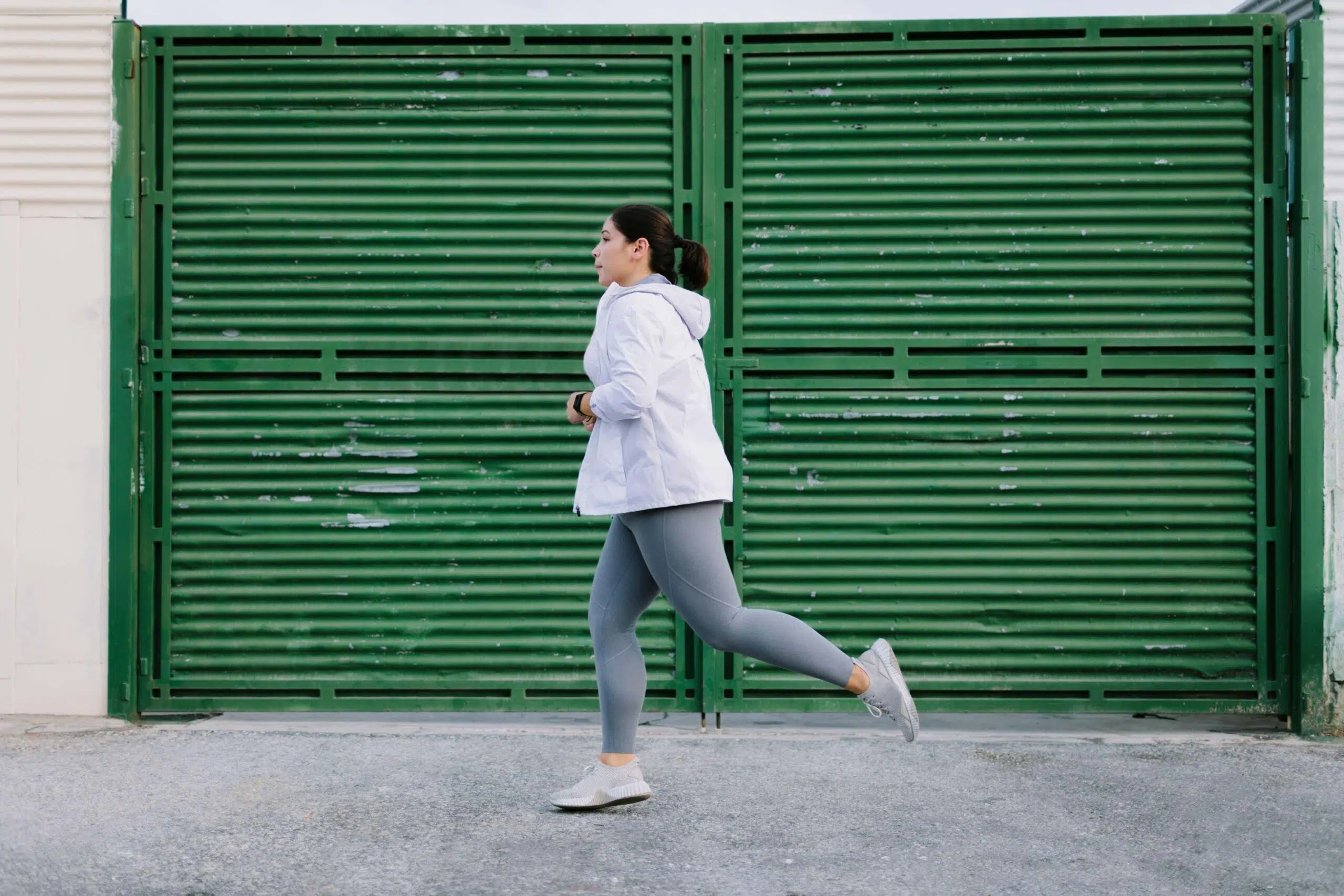 Person running against green shutter scaled