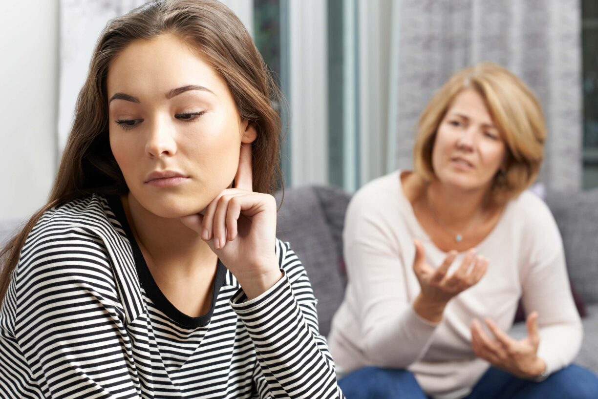 teen looks away from mum in disgust