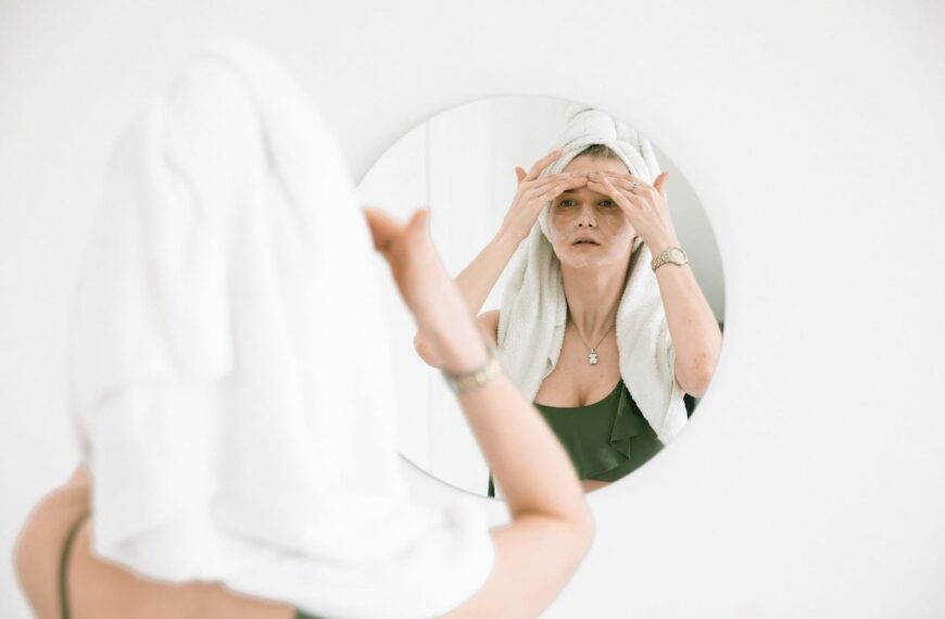 woman looking after skin in mirror