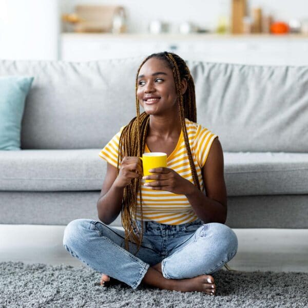 woman sits cross legged on the floor scaled