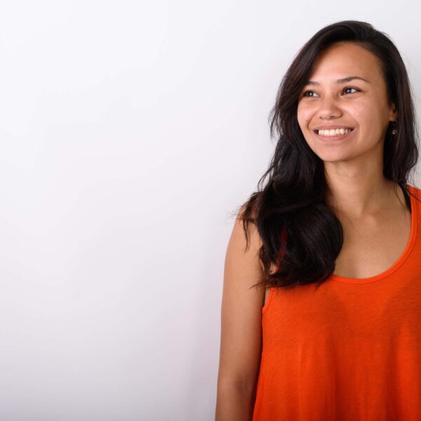 woman wearing orange top smiles scaled