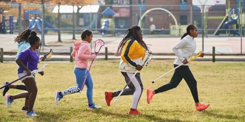 young people run across sports field