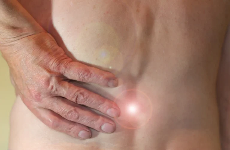 hand placed behind bare back