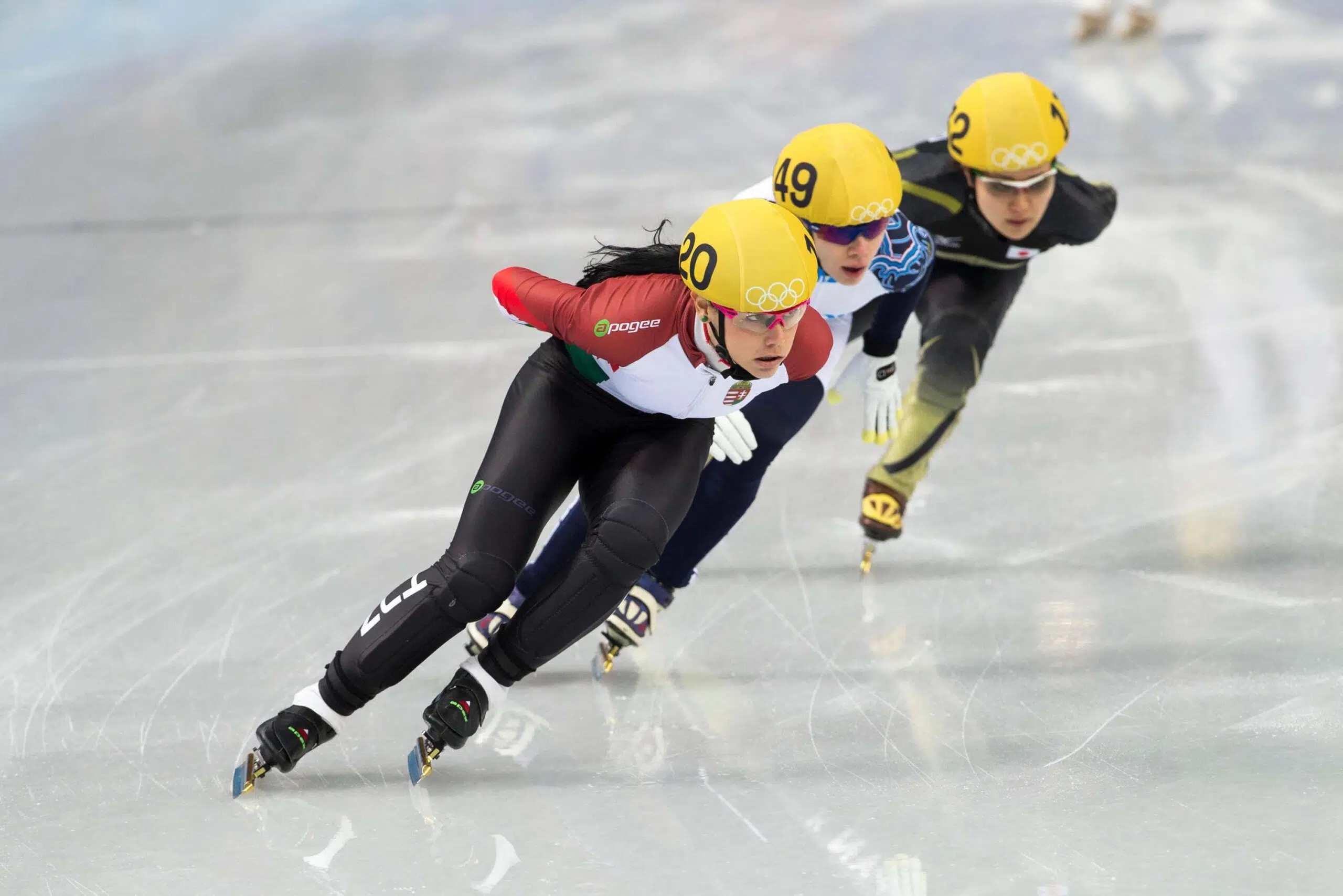 Speed skaters on ice scaled