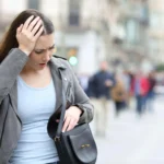 woman walks with hand on head scaled