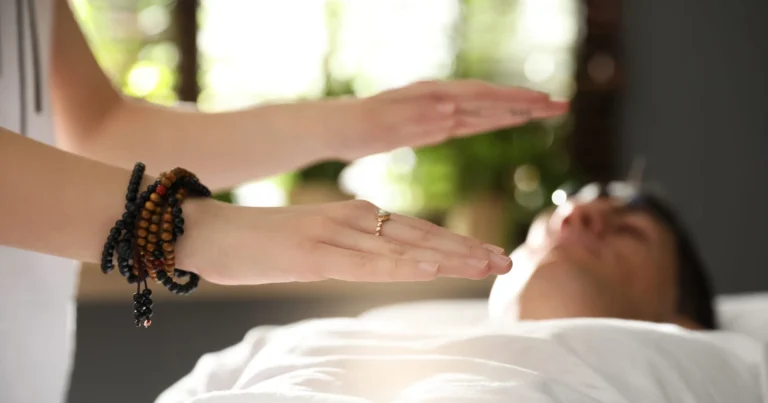 Man during crystal healing session in therapy room