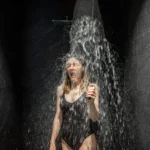 Woman hardening with shower of ice cold water