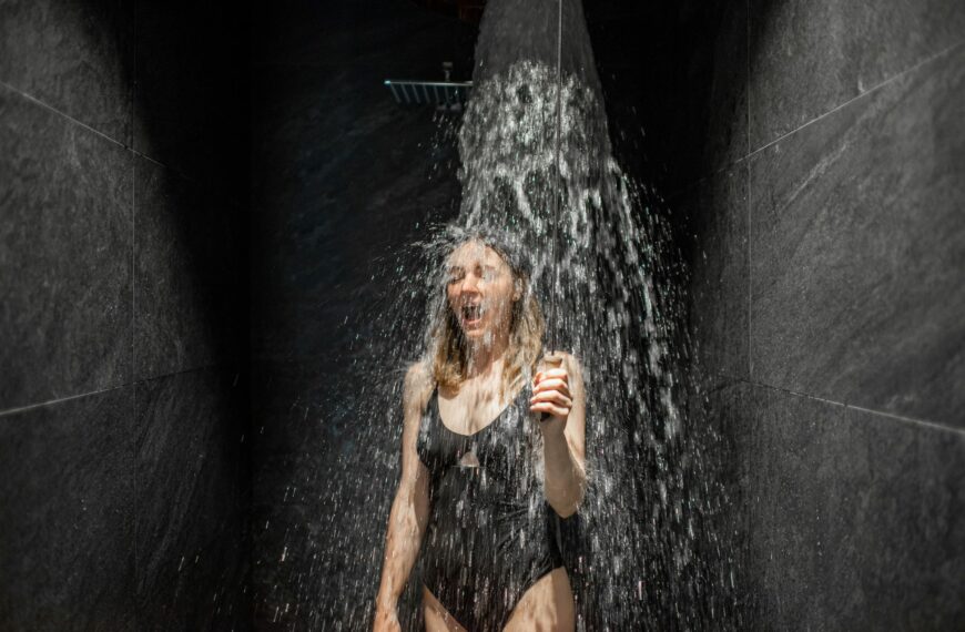 Woman hardening with shower of ice cold water