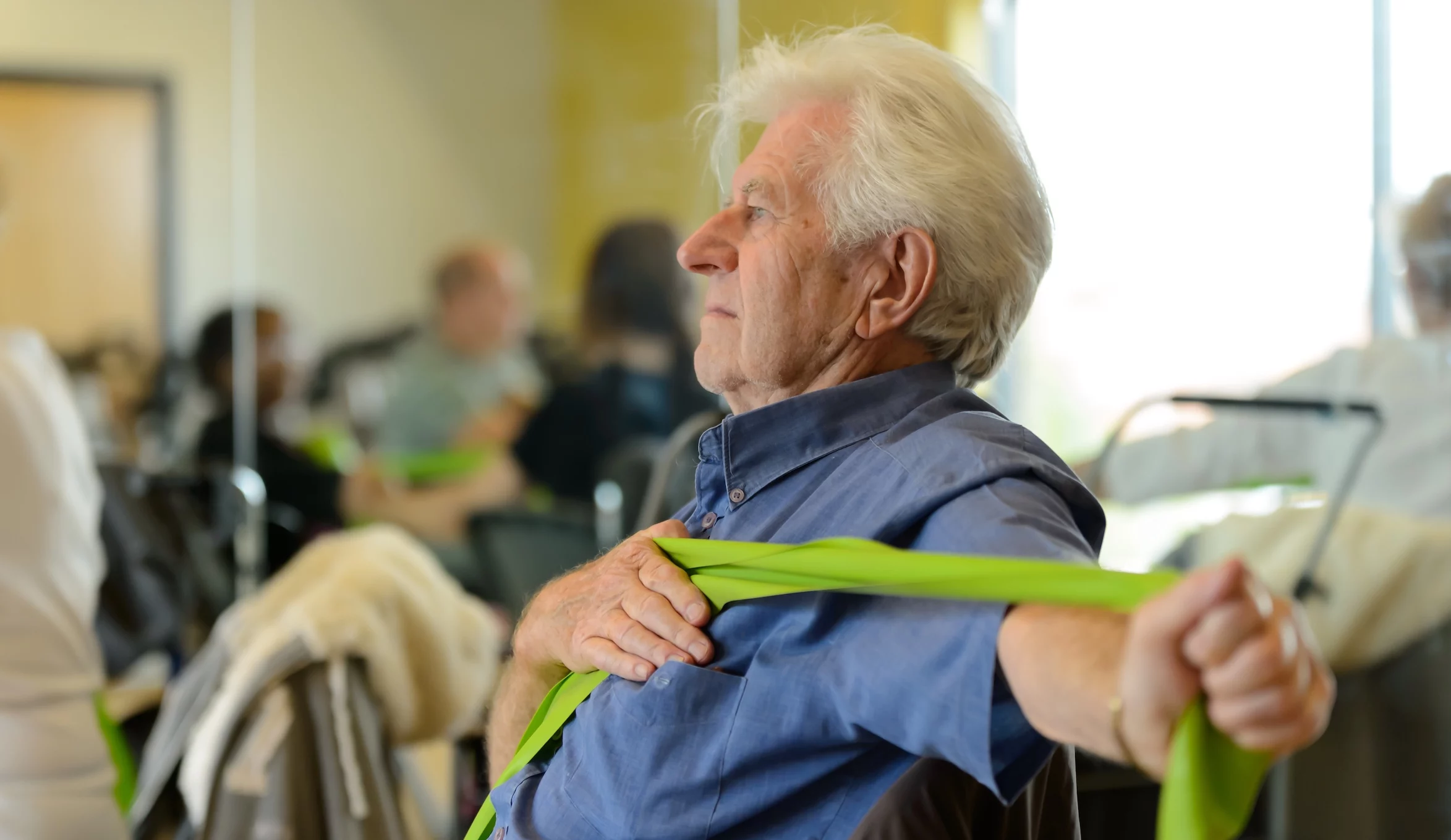 Mature man stretches exercise band