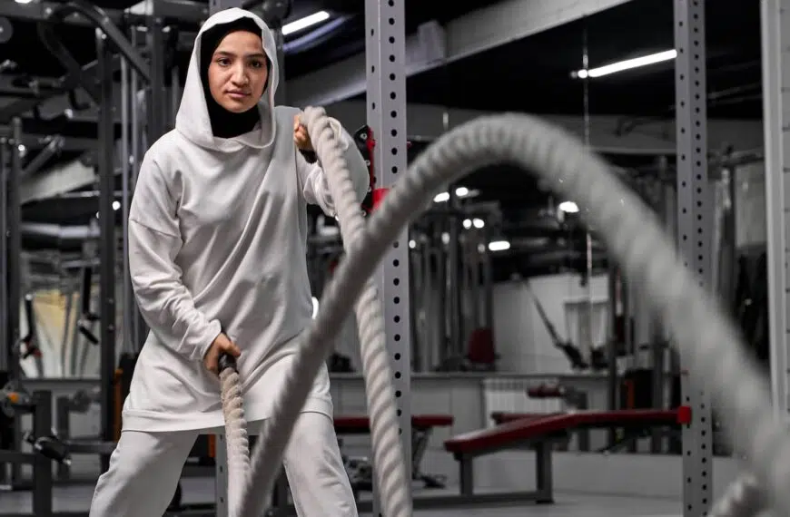 muslim athletic woman working out with ropes at cross fit gym e1648489953587