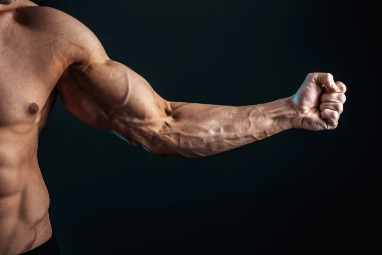 tense arm clenched into fist veins bodybuilder muscles