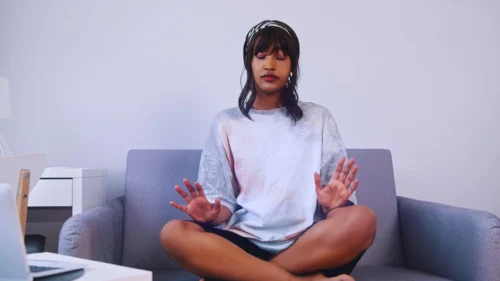 WOMAN SITS LOOKING TO MEDITATE scaled