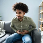 man holds stomach