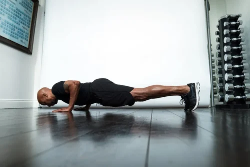 man performs push up