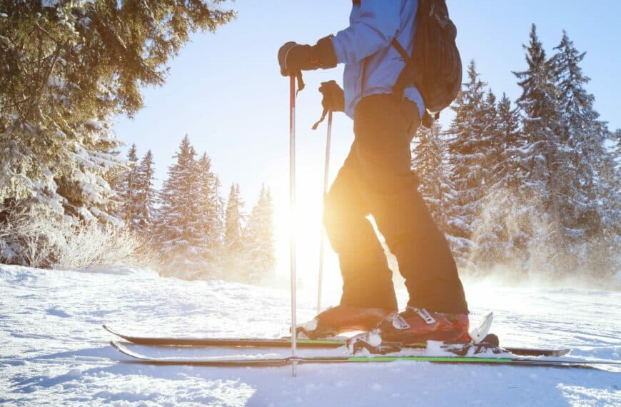 skiier with sunsining through backdrop e1651228996874
