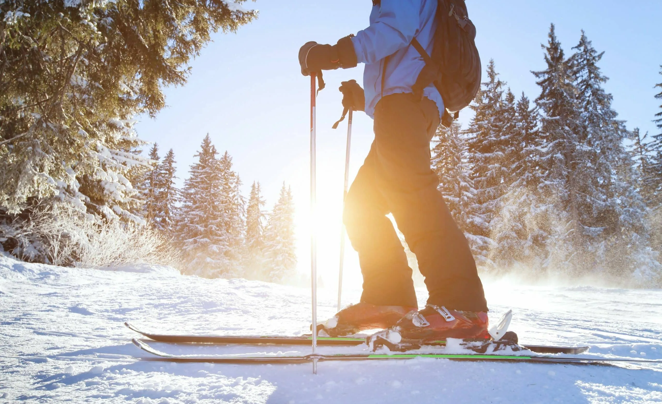 skiier with sunsining through backdrop