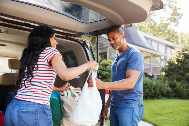 woman passes shopping bag to man scaled