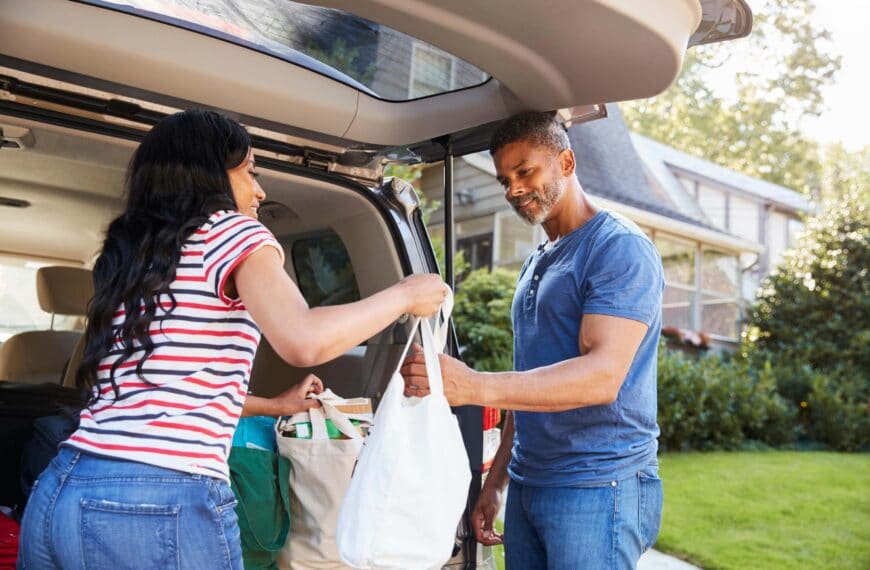woman passes shopping bag to man scaled