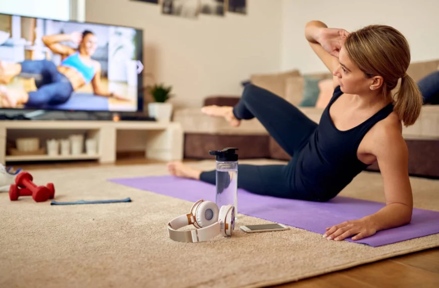 woman works out in front of television