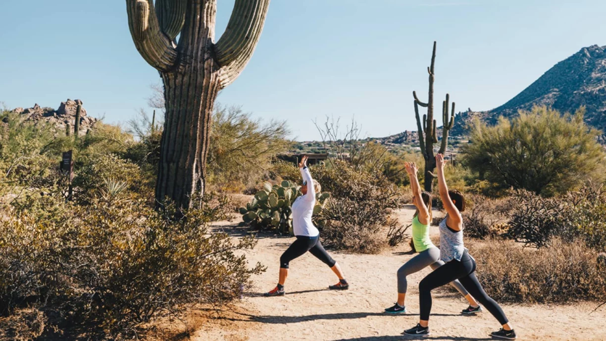 Yoga group perform poses in the desert
