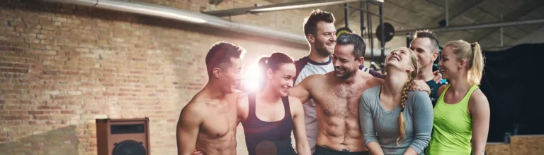 Group of eight athletic young friends in gym