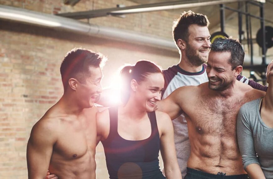 Group of eight athletic young friends in gym
