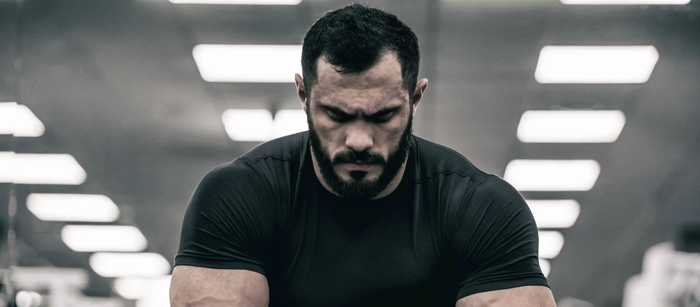 fit strong man looks sad