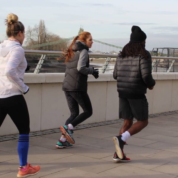 people running along londons embankment