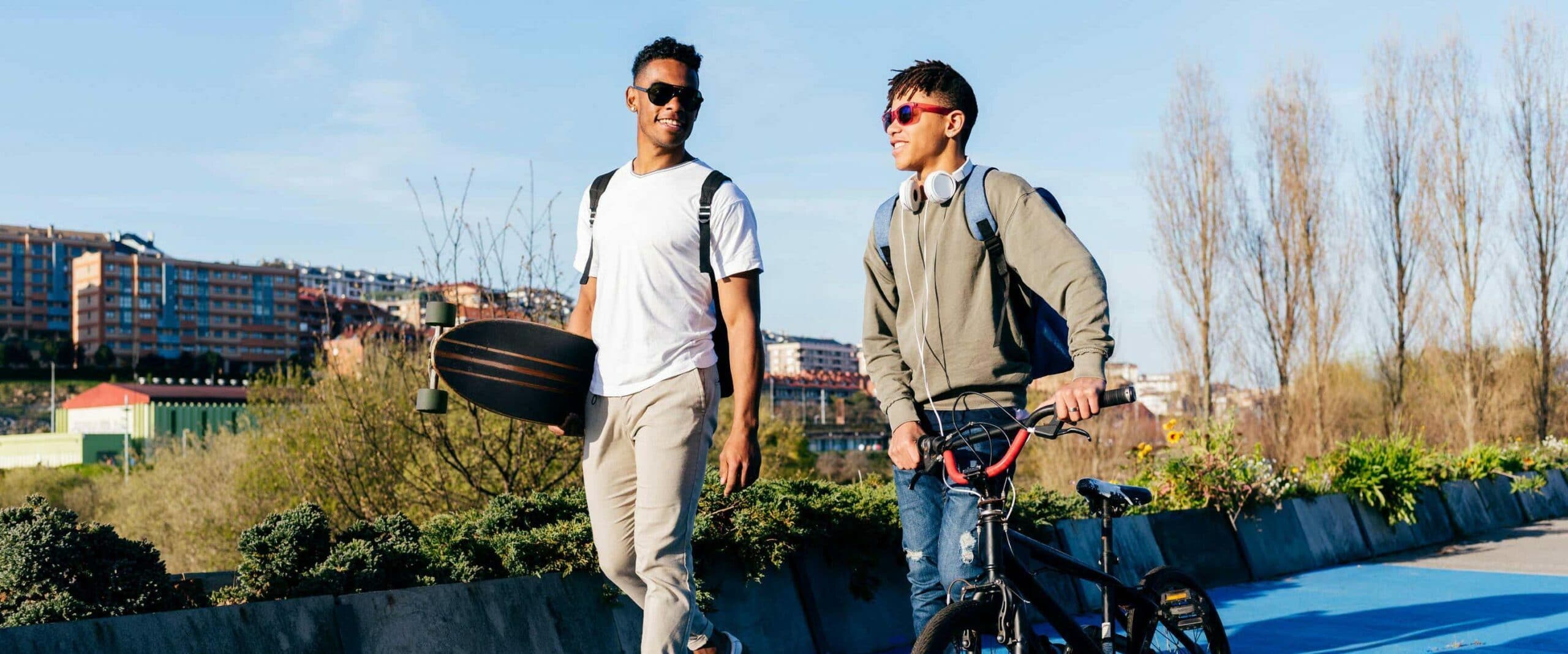 Two guys with bike and skateboard scaled e1651680742443