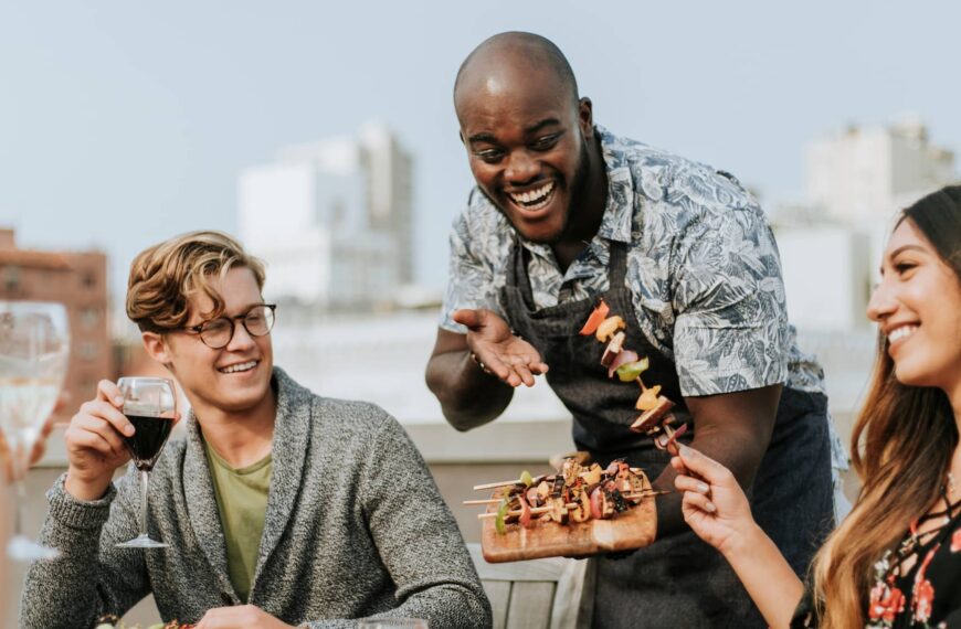 Cheerful chef serving grilled vegan barbeque skewers