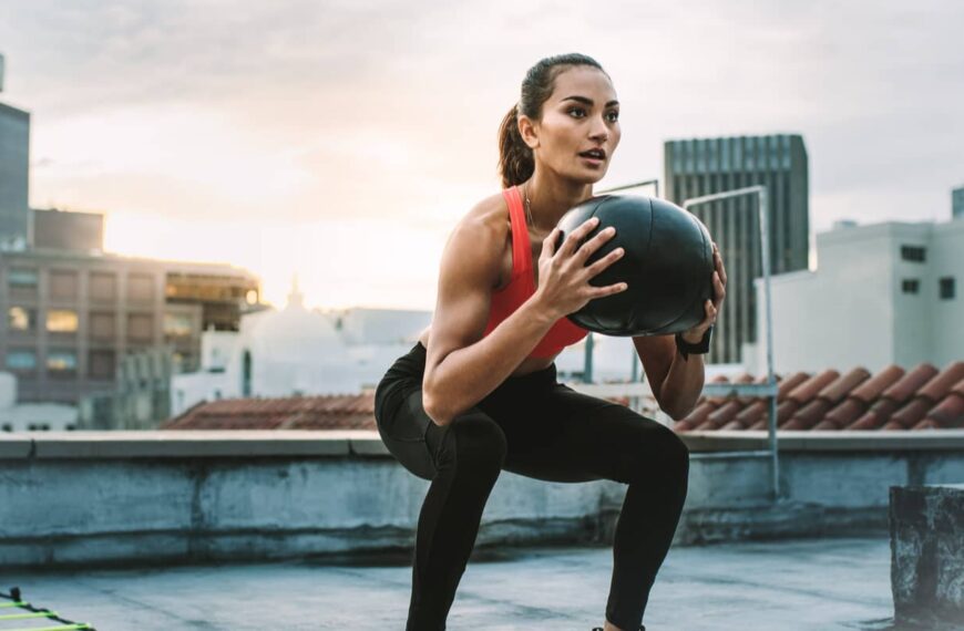 fit woman exercises with medicine ball e1654791154664