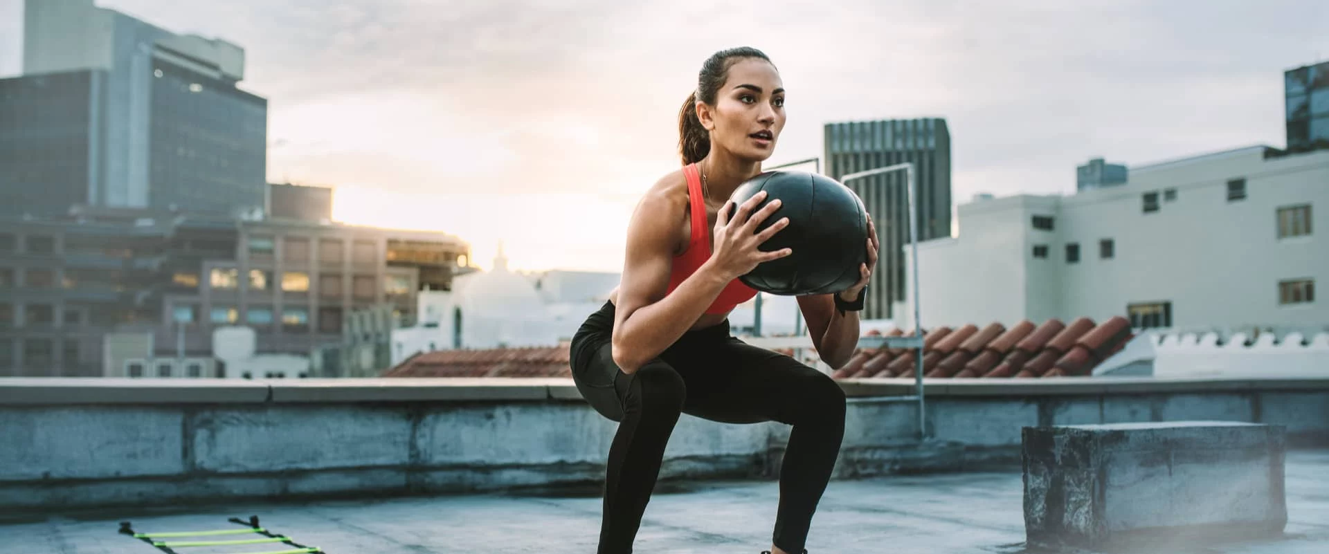 Fit woman exercises with medicine ball e1654791154664