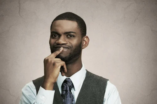 man holds finger to mouth scaled