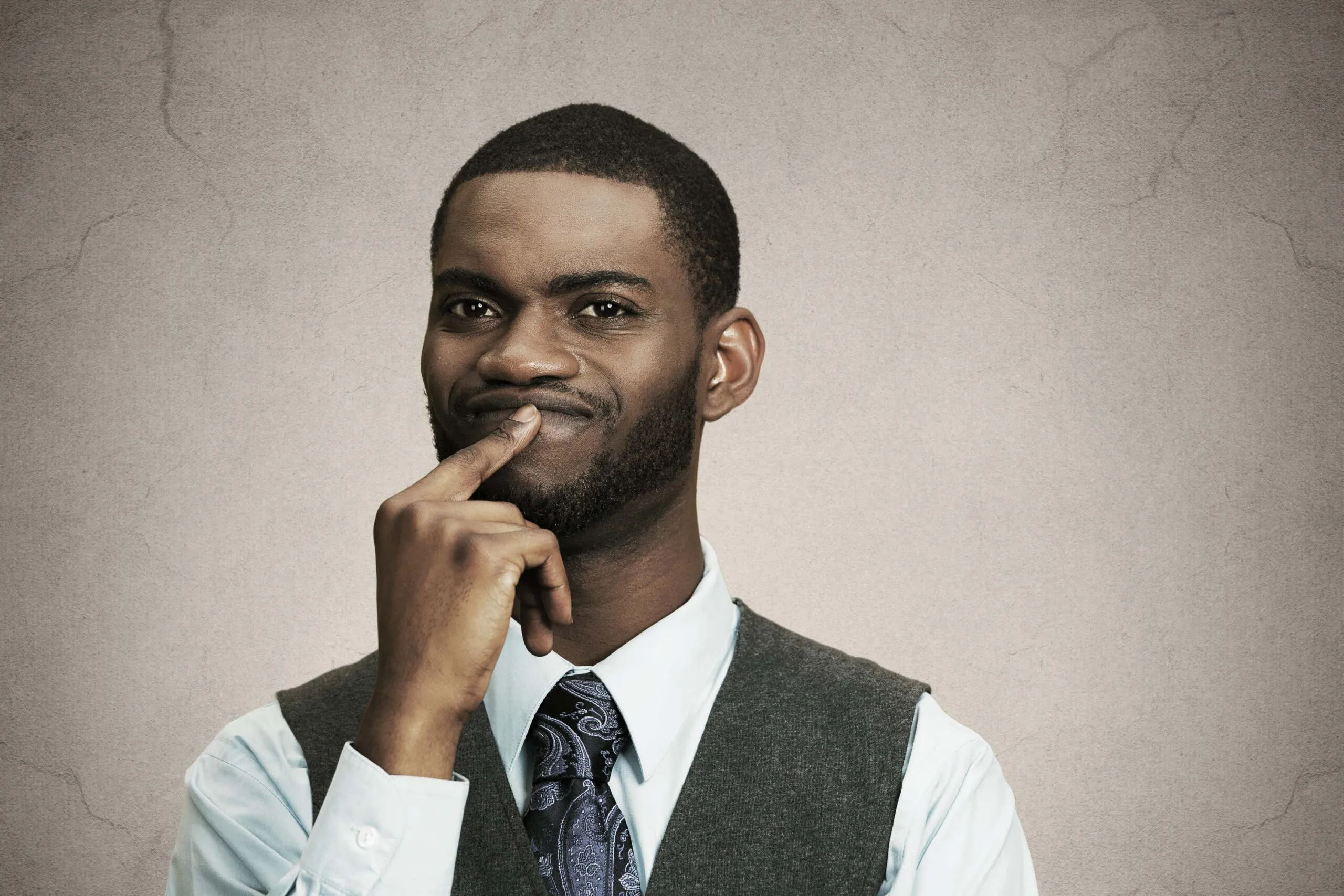 man holds finger to mouth scaled