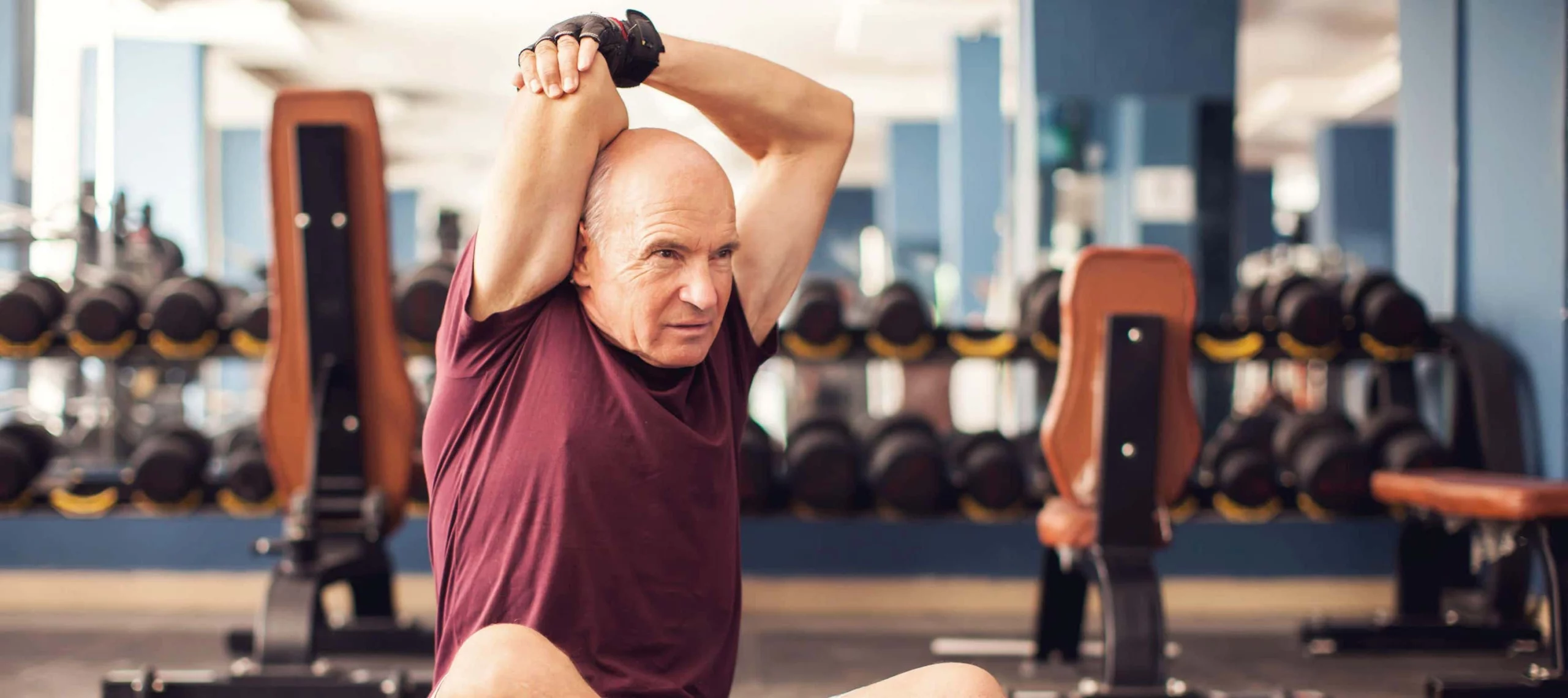 Man stretches hands above head scaled