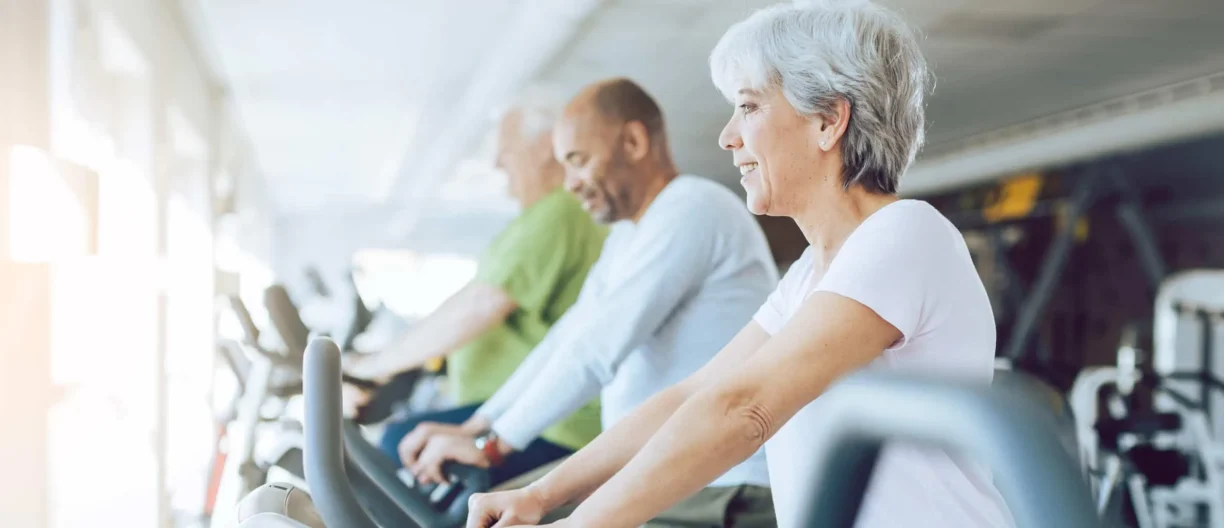 people exercising on gym equipment