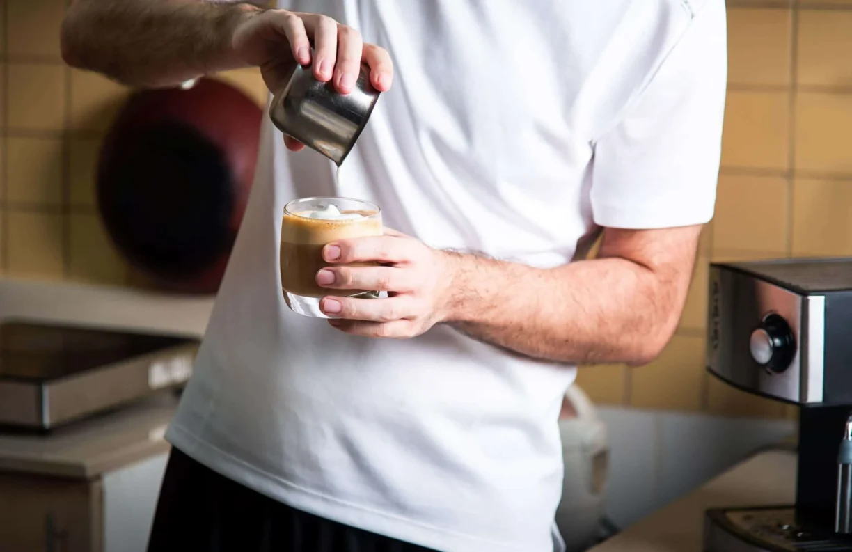 person pours a coffee