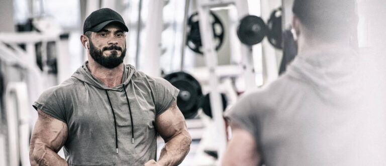 powerful strong young man showing muscle in sport fitness gym