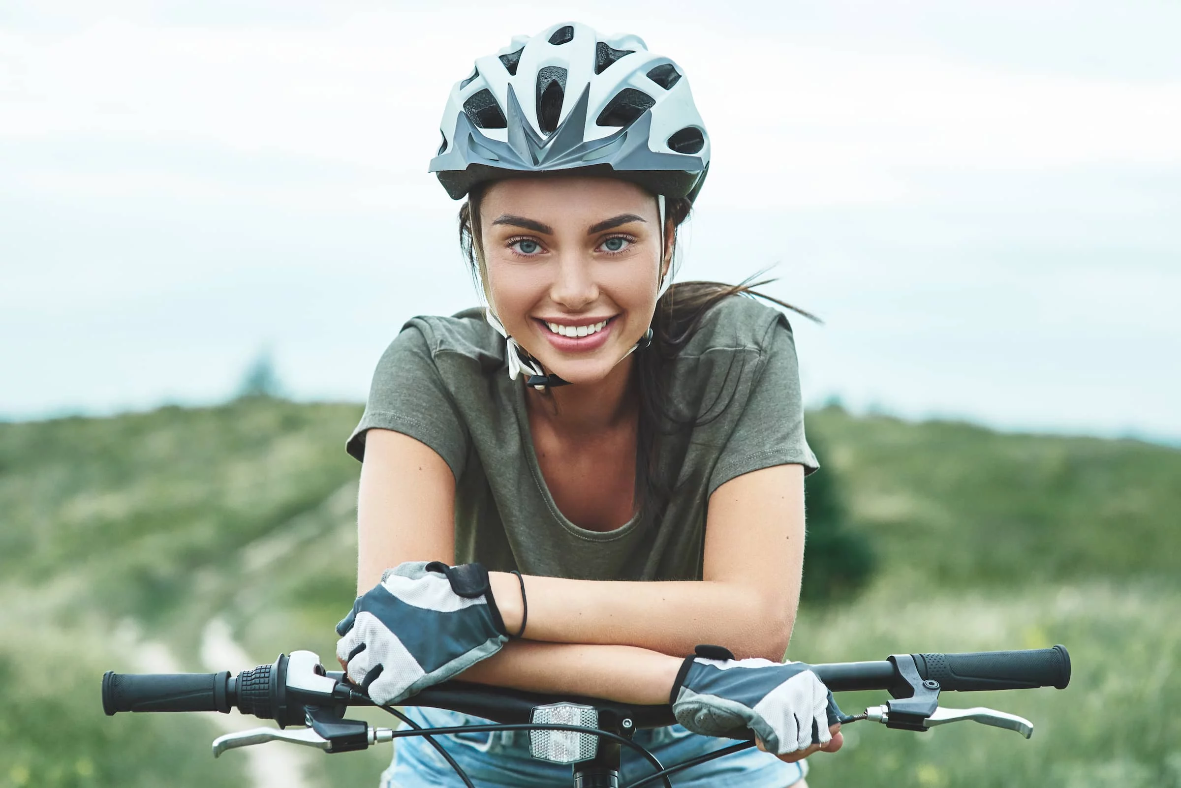 Woman cyclist sits smiling