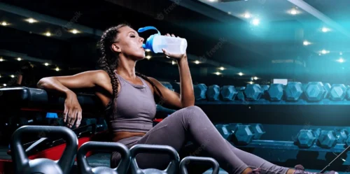 woman drinks from sports bottle