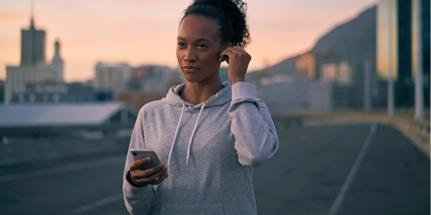 young fit woman holds phone in hand