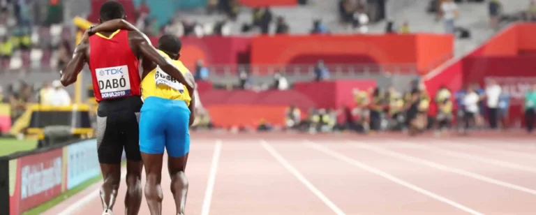 athletes helping each other on track scaled