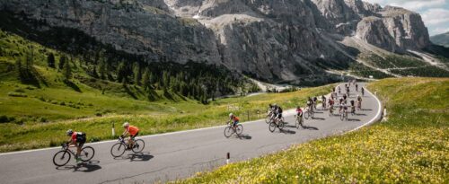 cyclists race on road in italian mountains
