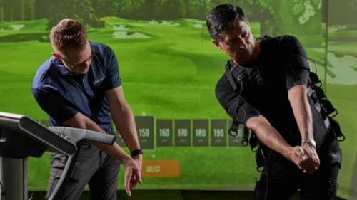 practising golf swing wearing ems suit