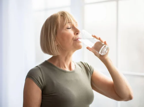 woman drinks a glass of water