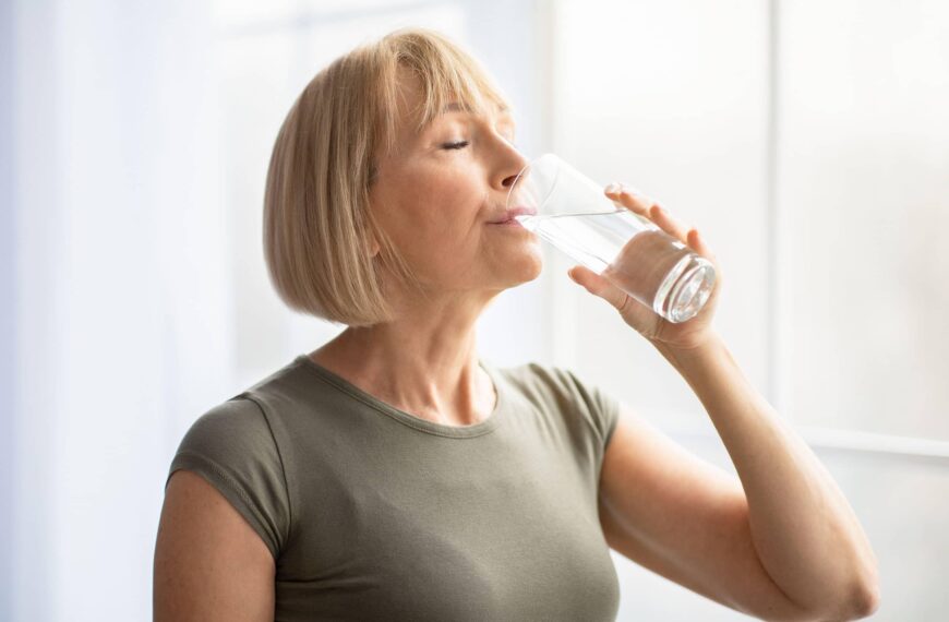 woman drinks a glass of water