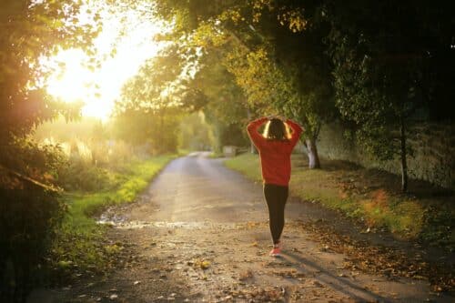 woman walks in sunset