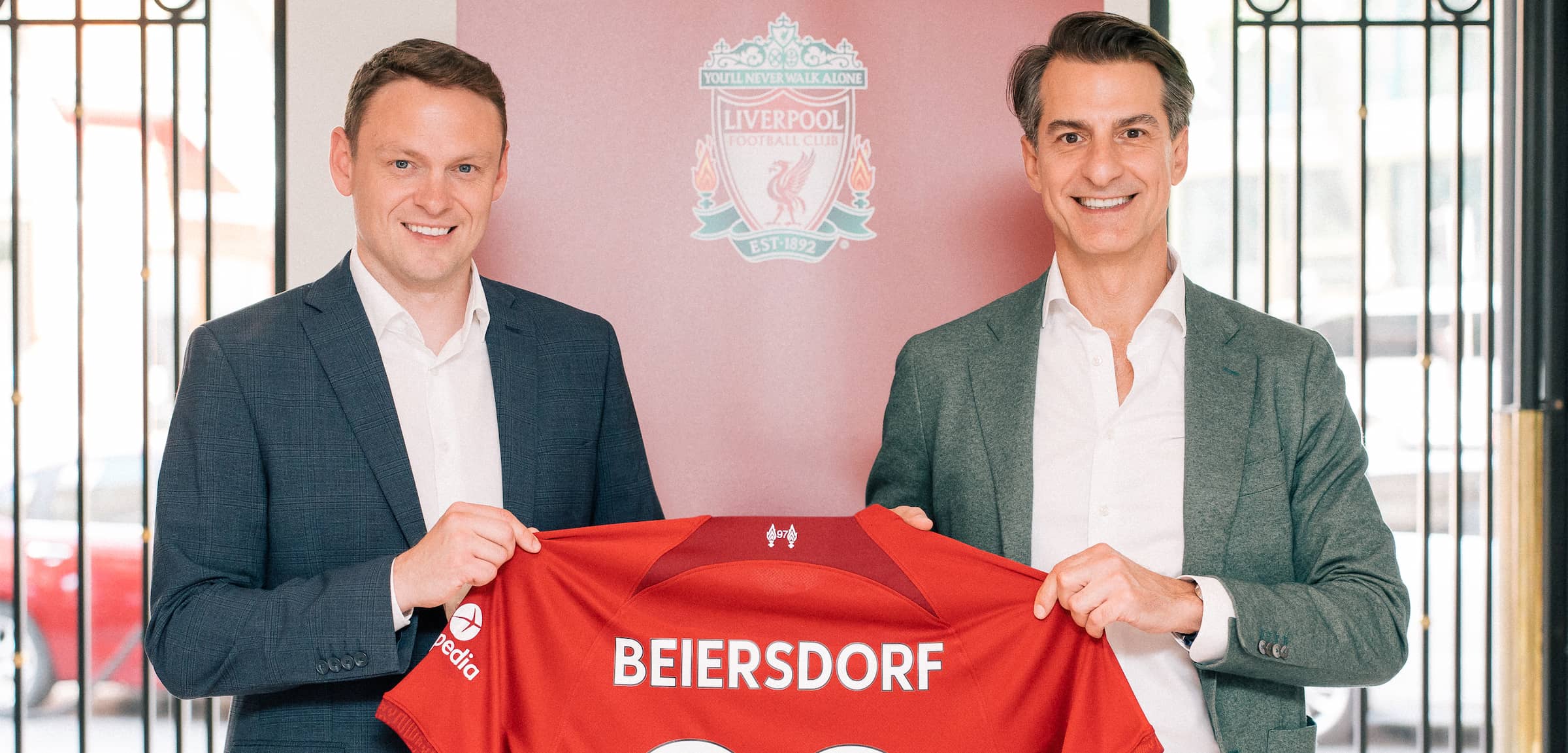 Ben latty liverpool fc commercial director and oswald barckhahn member of the executive board beiersdorf